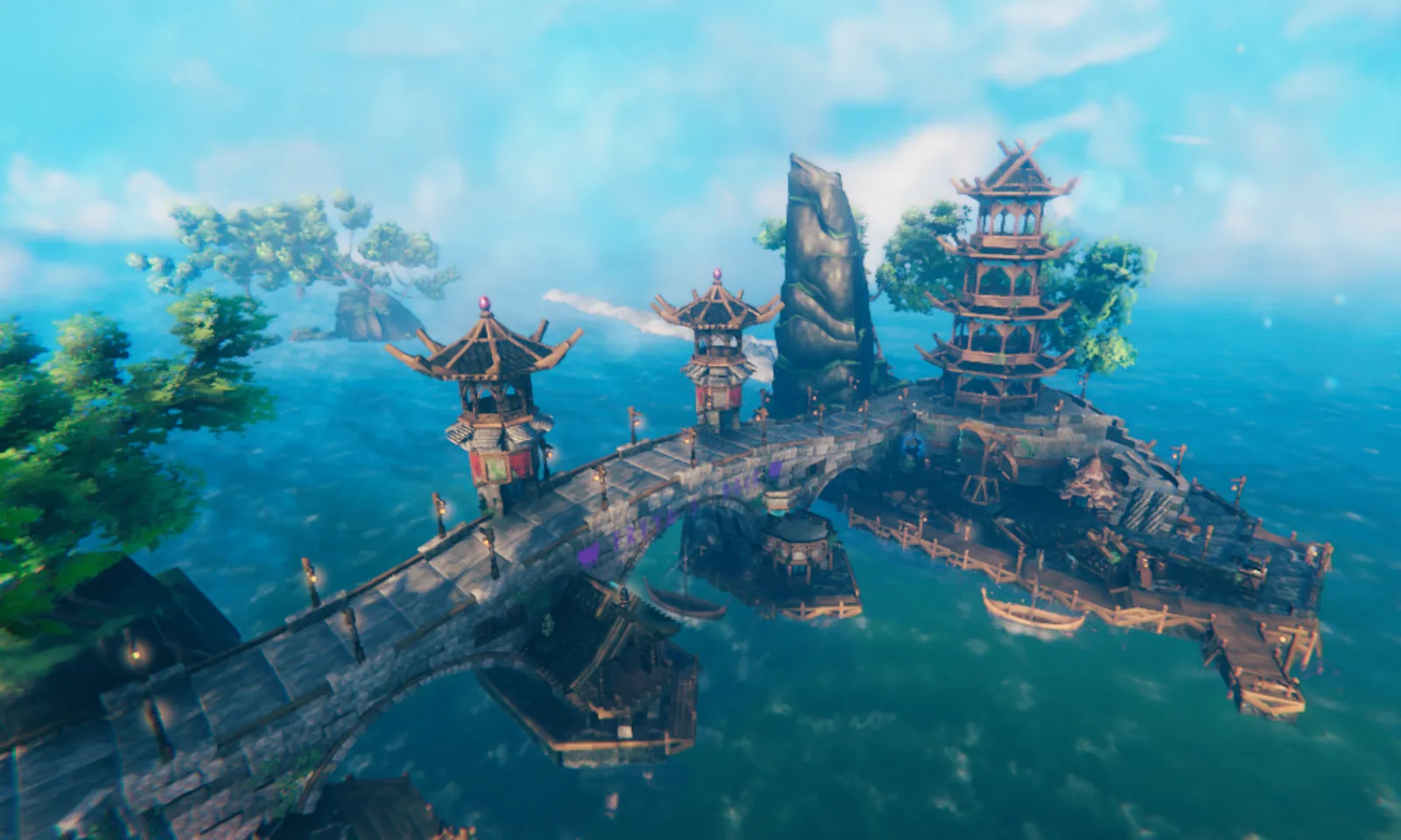 Grand arched stone bridge and multi-tier pagoda fortress spanning turquoise ocean waters in a player-built Valheim world